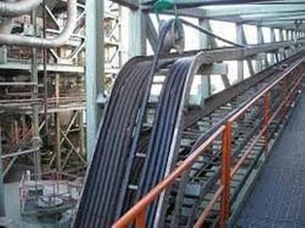 Cable trays and conduit runs through an industrial plant room