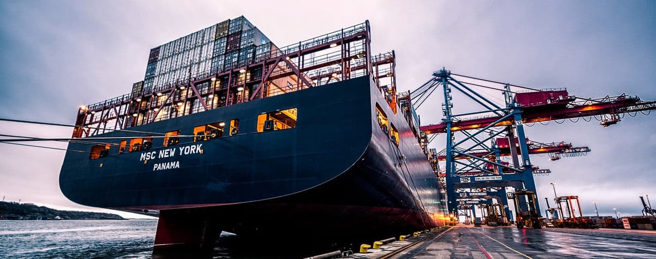 Container vessel alongside gantry cranes at a commercial port berth