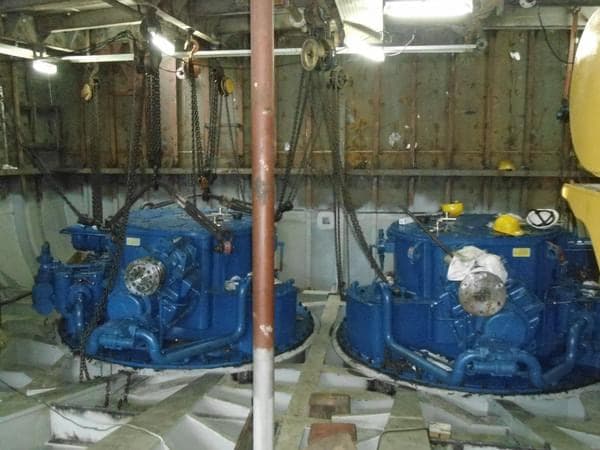 Blue-painted propulsion machinery in a vessel's engine room