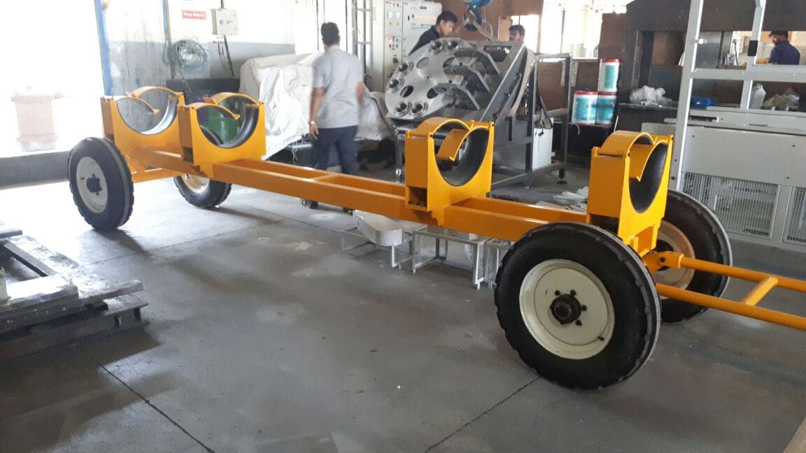 Completed yellow torpedo handling trolleys on the workshop floor